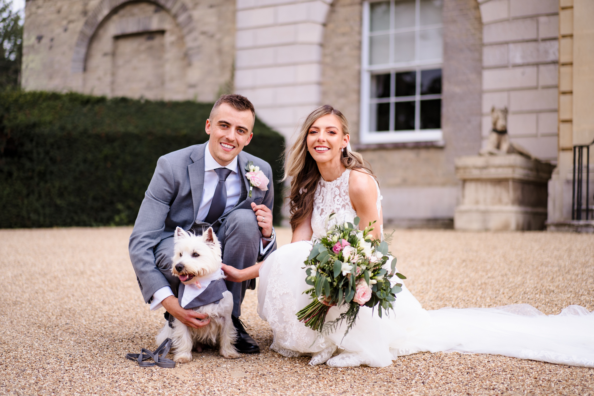 Wedding couple in front of Hatfield Place with a west highland terrier